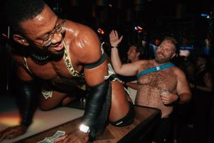 A go-go dancer getting his butt smacked by a tipper
