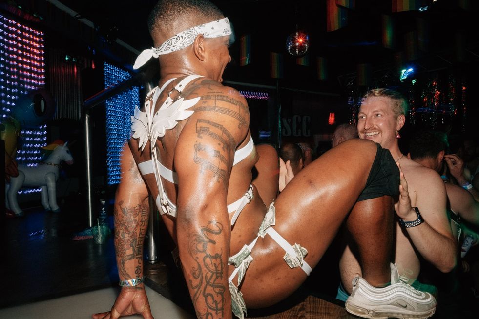 A go-go dancer on stage getting tipped