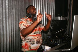 A DJ dancing behind the booth