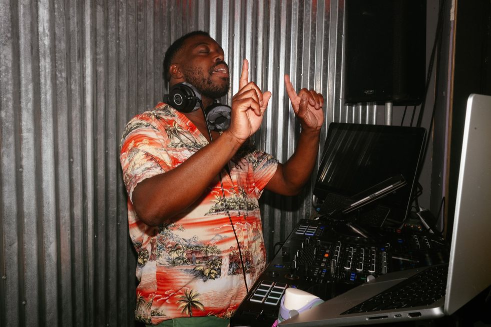 A DJ dancing behind the booth