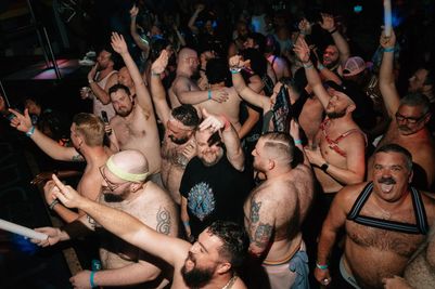 A large group of people dancing in a club