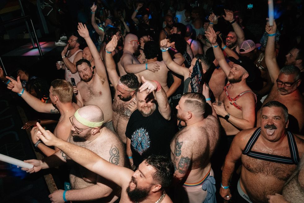 A large group of people dancing in a club