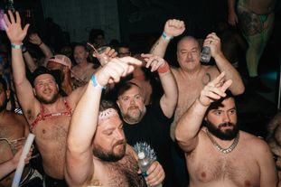 A group of people dancing in a club