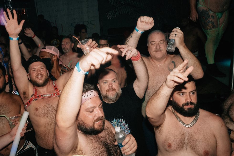 A group of people dancing in a club
