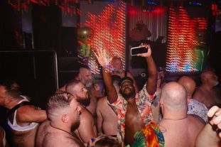 A group of gay men dancing in a club
