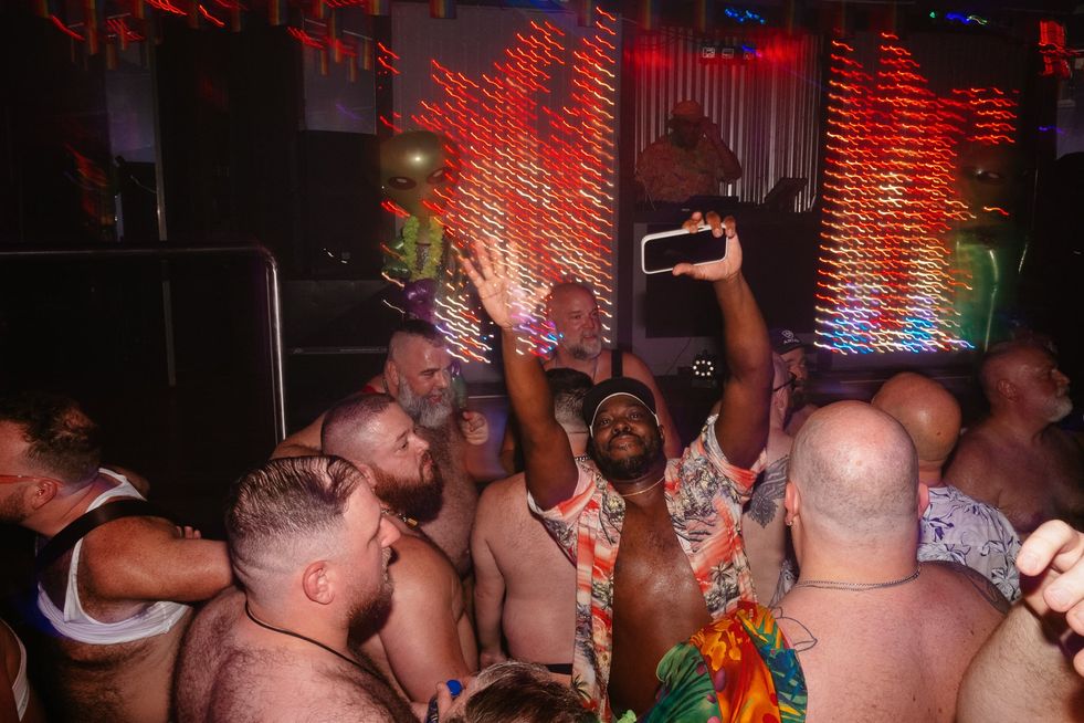 A group of gay men dancing in a club