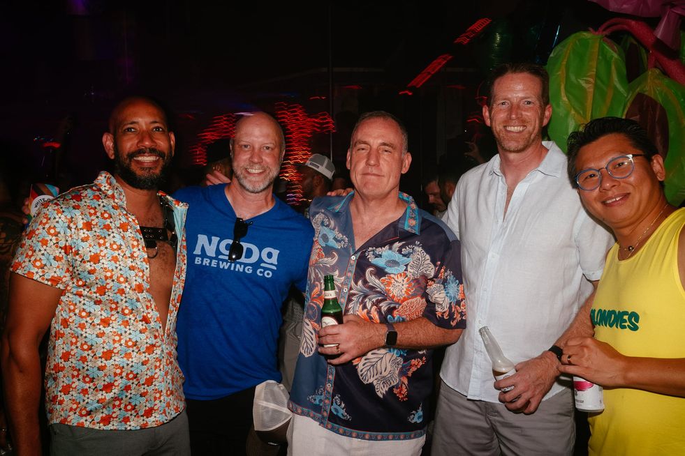 A group of men pose for a photo