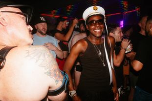 A group of queer men on the dance floor